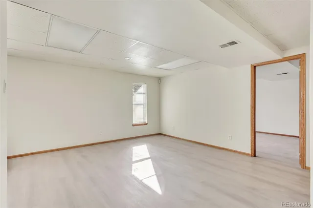 a view of a livingroom with wooden floor and stairs
