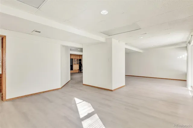 a view of an empty room with furniture