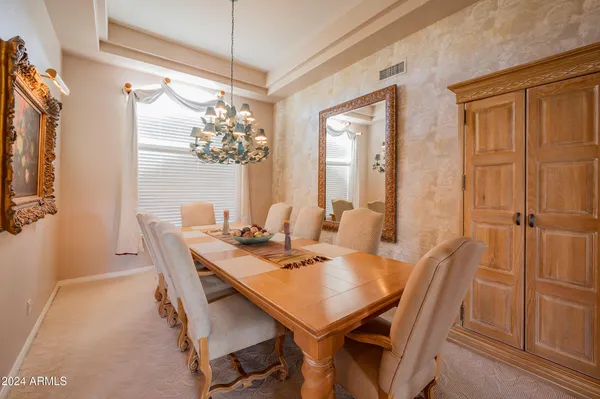 a view of a dining room with furniture and chandelier