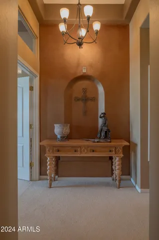 a living room with furniture a fireplace and a chandelier