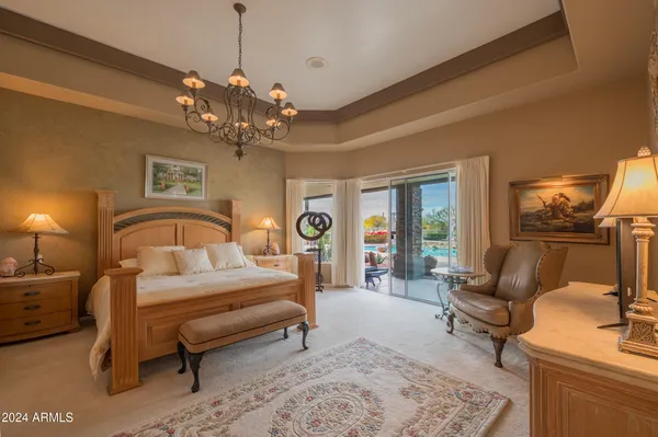 a bedroom with a bed a couch and dresser