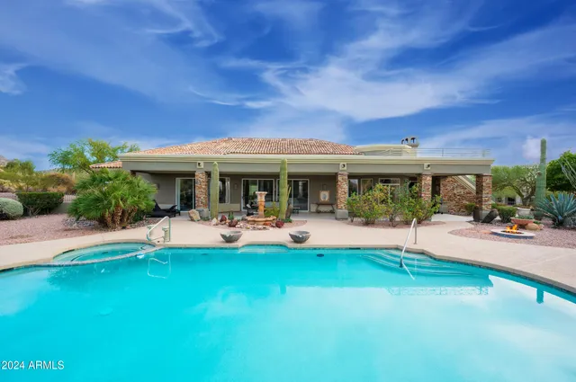 a living room with furniture and a dining table