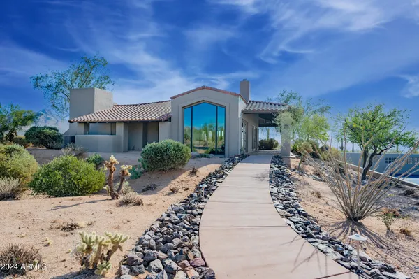 a spacious bedroom with a bed a couch and dresser