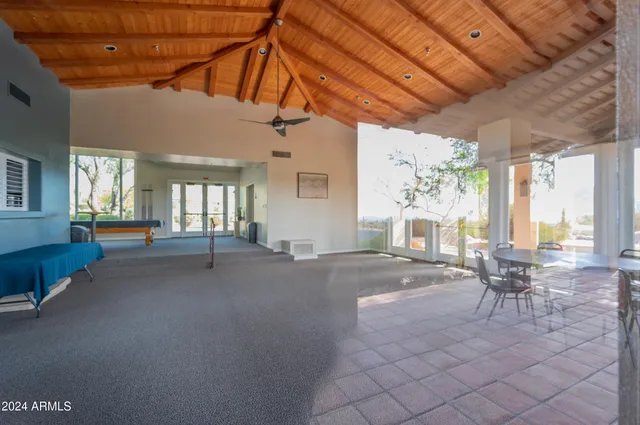a spacious bathroom with a granite countertop sink a bathtub and next to a window