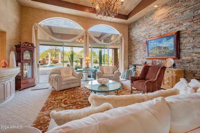 a living room with furniture and a chandelier