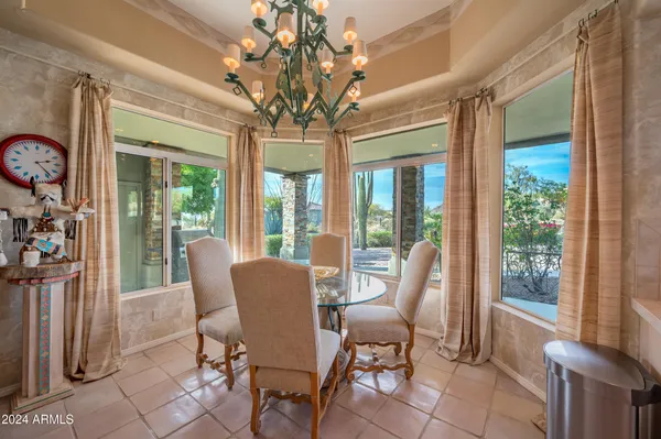 a view of a dining room with furniture wooden floor and chandelier
