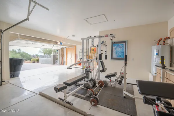 a room with gym equipment and a large window