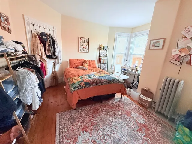 a bed sitting in a bedroom next to a window