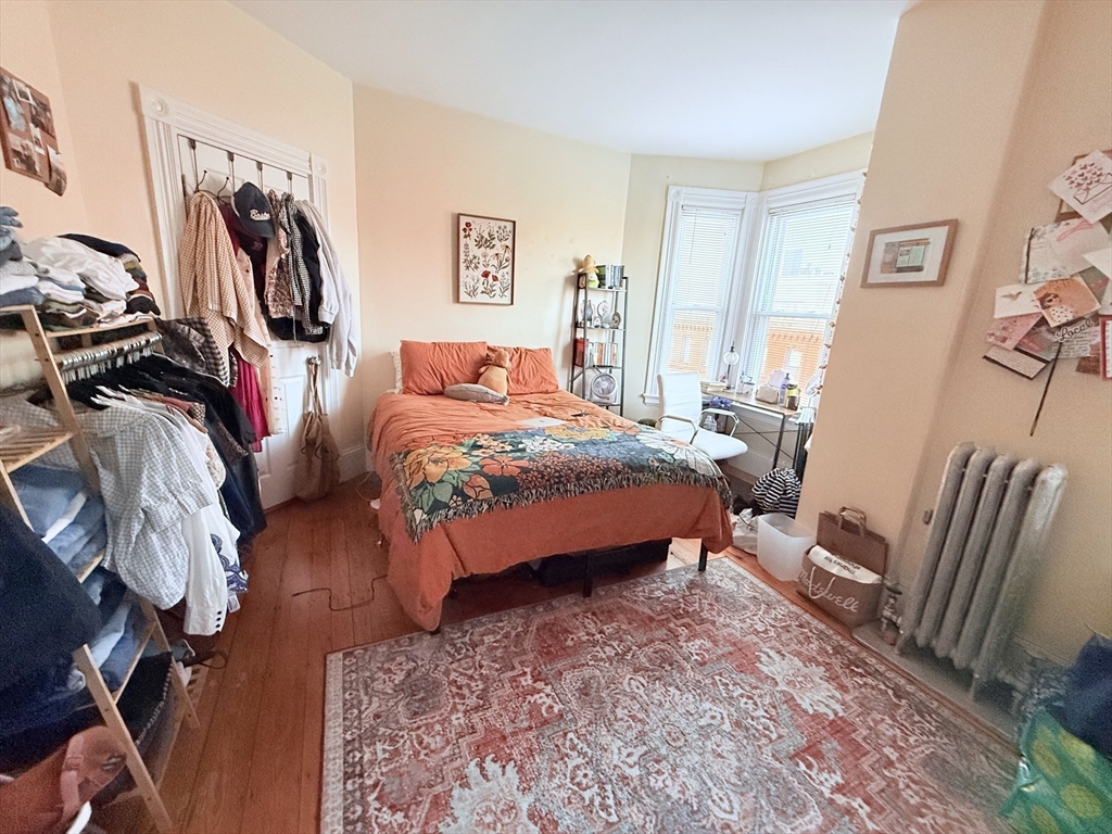 220-224 Washington Street, Unit 7A Brookline, MA 02445 - Photo 4 of 9 a bedroom with furniture and a couch