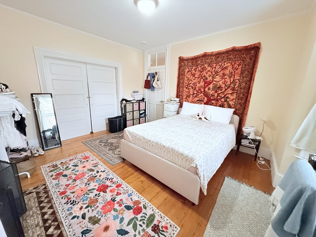 220-224 Washington Street, Unit 7A Brookline, MA 02445 - Photo 5 of 9 a bed sitting in a bedroom next to a window