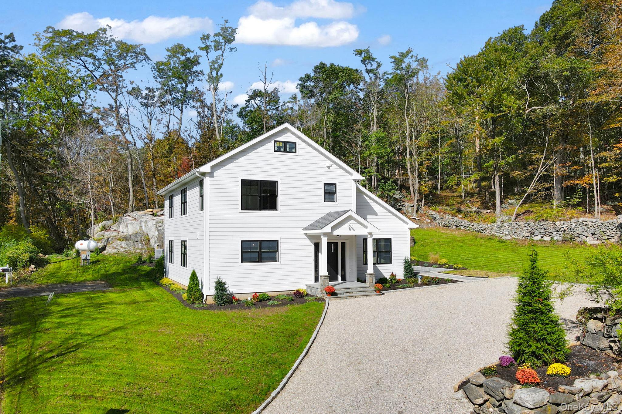 View of front of property featuring a cobblestone driveway