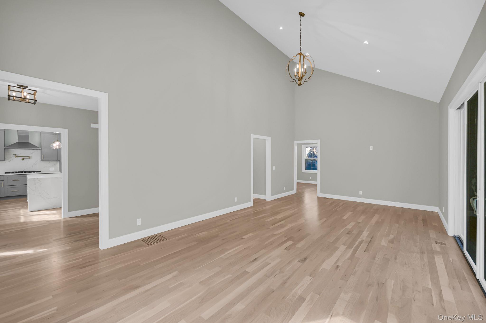 170 Brimstone Road Patterson, NY 12563 - Photo 11 of 48 featuring a chandelier, high vaulted ceiling, and light wood-type flooring