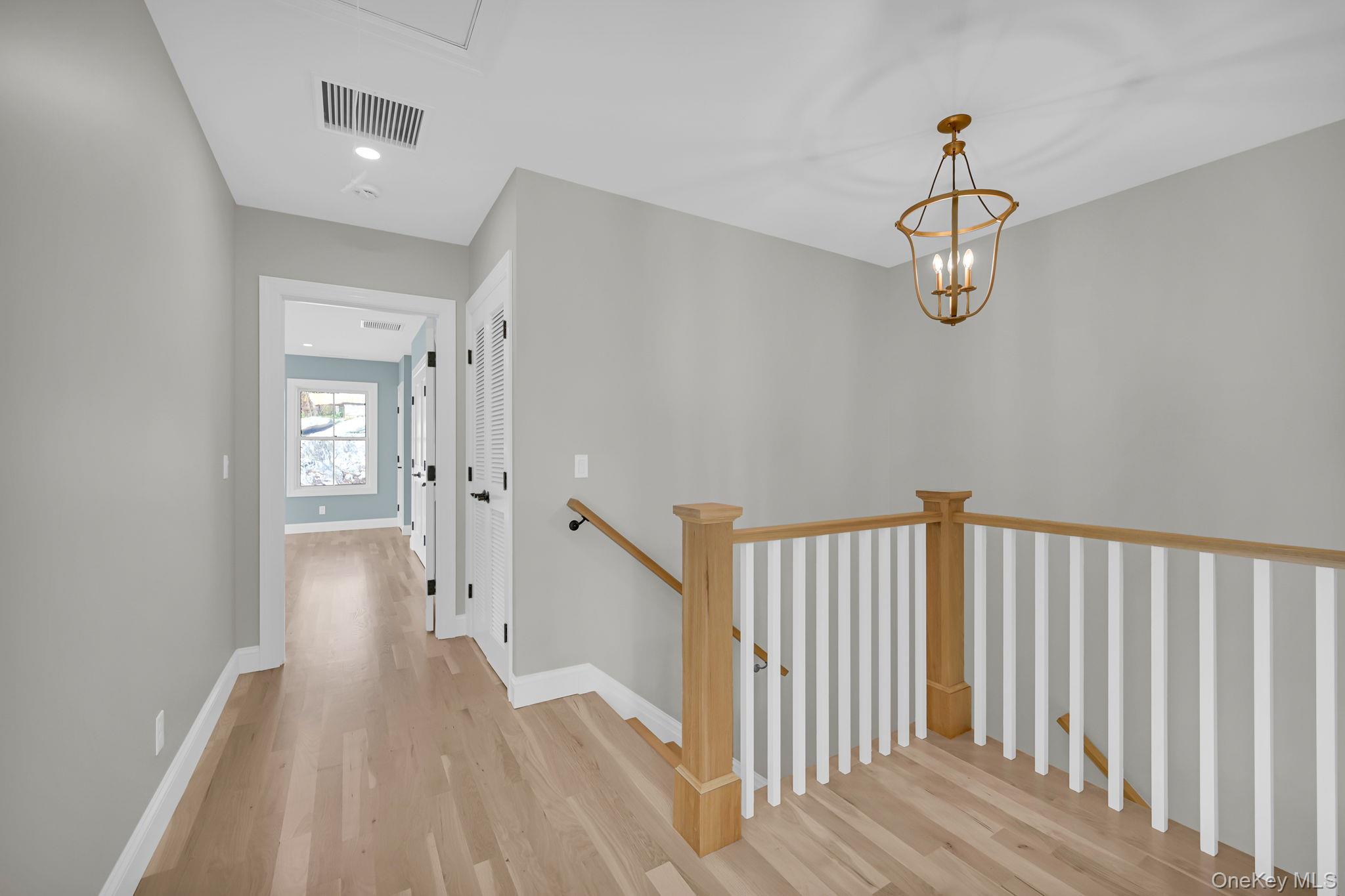 170 Brimstone Road Patterson, NY 12563 - Photo 16 of 48 Corridor featuring an upstairs landing, light wood-style flooring, recessed lighting, and a chandelier