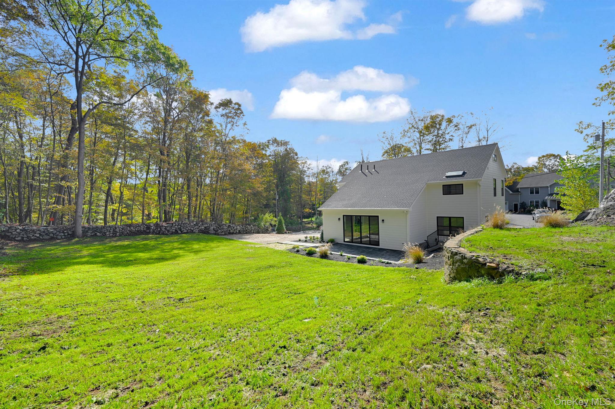 170 Brimstone Road Patterson, NY 12563 - Photo 39 of 48 Back of house with a patio area and a lawn