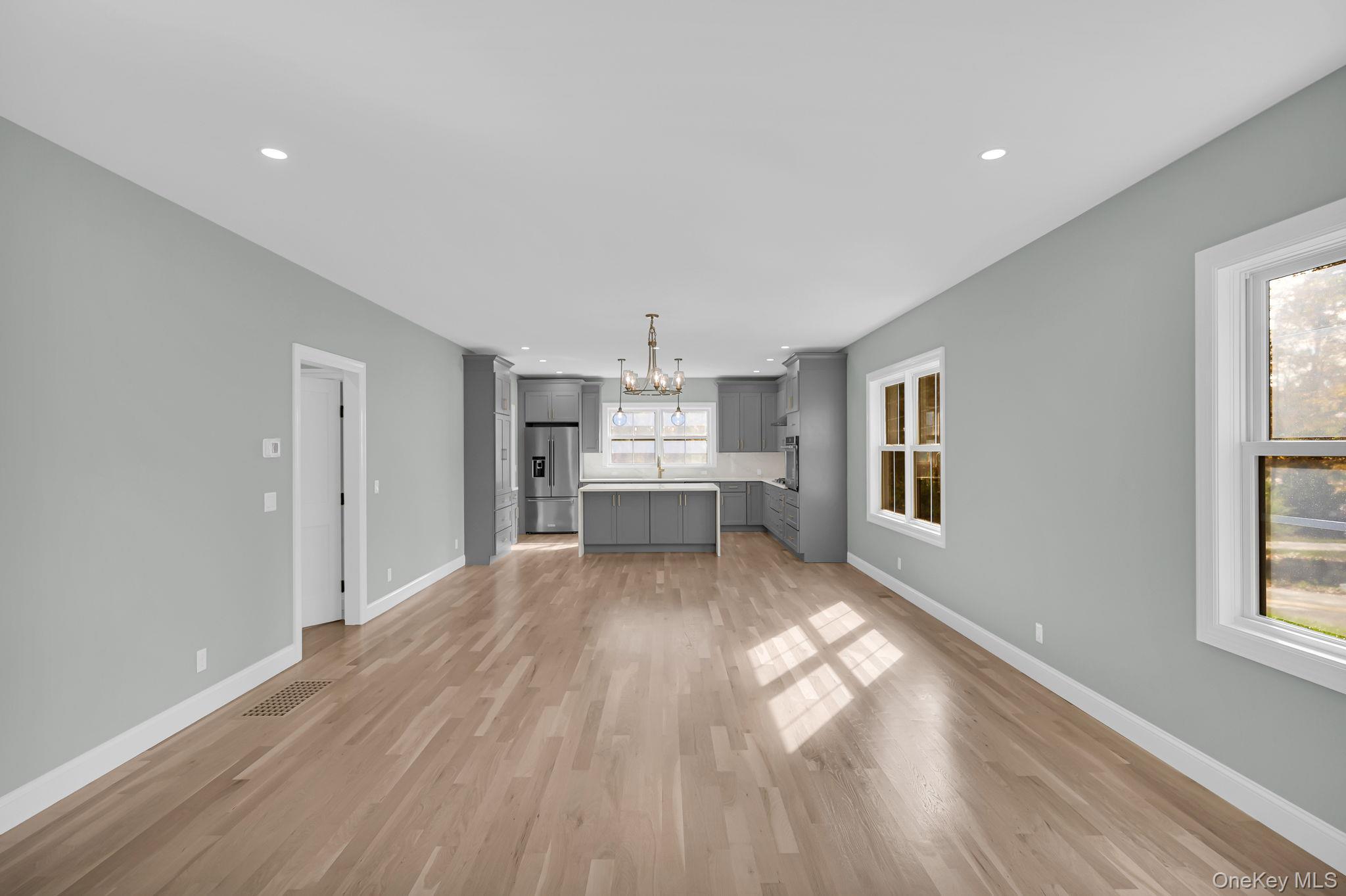 170 Brimstone Road Patterson, NY 12563 - Photo 7 of 48 Unfurnished living room featuring light wood finished floors, a chandelier, and recessed lighting
