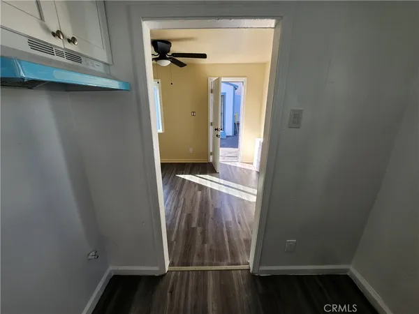 a view of a room with wooden floor