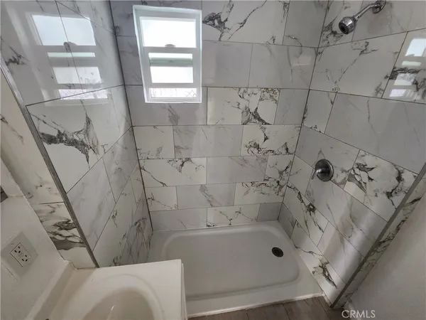 a bathroom with a bathtub and a shower