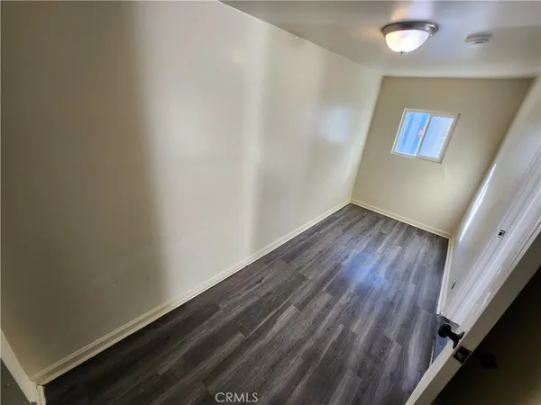a view of an empty room and wooden floor