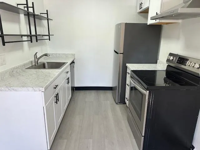 a kitchen with a sink and a refrigerator