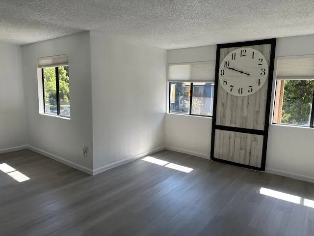 an empty room with wooden floor and a window