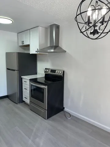 a kitchen with stainless steel appliances a stove a microwave and cabinets
