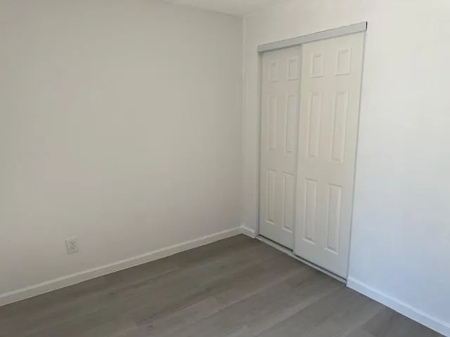 an empty room with wooden floor