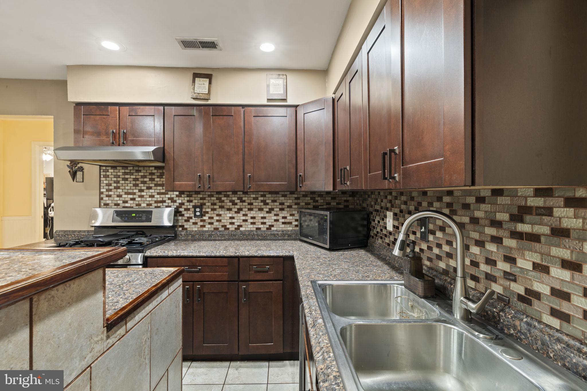 205 Franklin Avenue Berlin, NJ 08009 - Photo 12 of 36 a kitchen with granite countertop a sink and a stove top oven