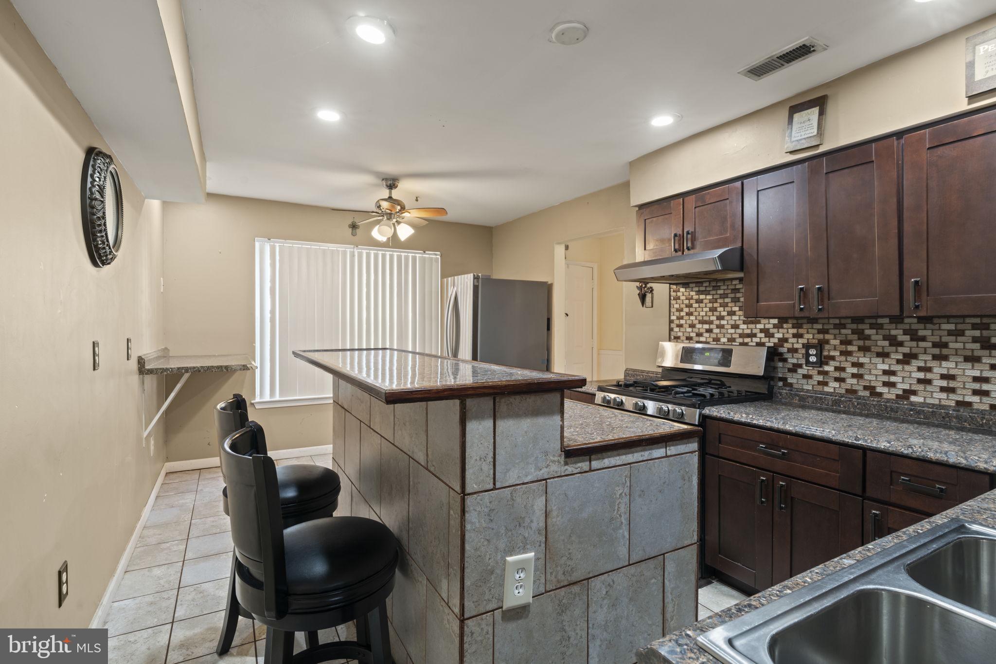 205 Franklin Avenue Berlin, NJ 08009 - Photo 13 of 36 a kitchen that has a sink and a stove in it