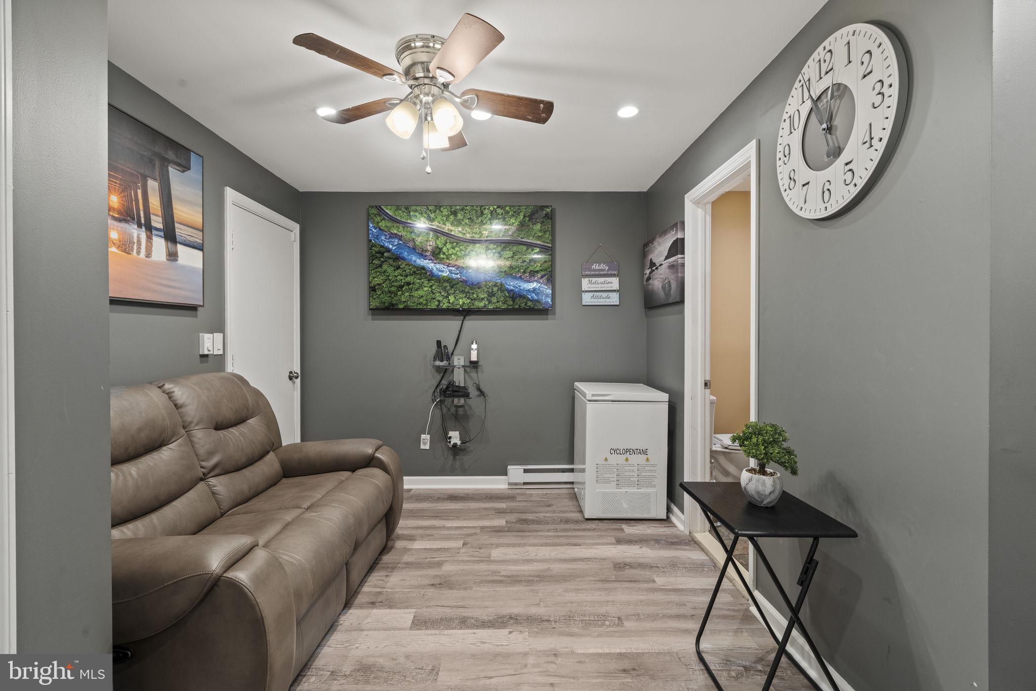205 Franklin Avenue Berlin, NJ 08009 - Photo 15 of 36 a living room with furniture a flat screen tv and a wall painting