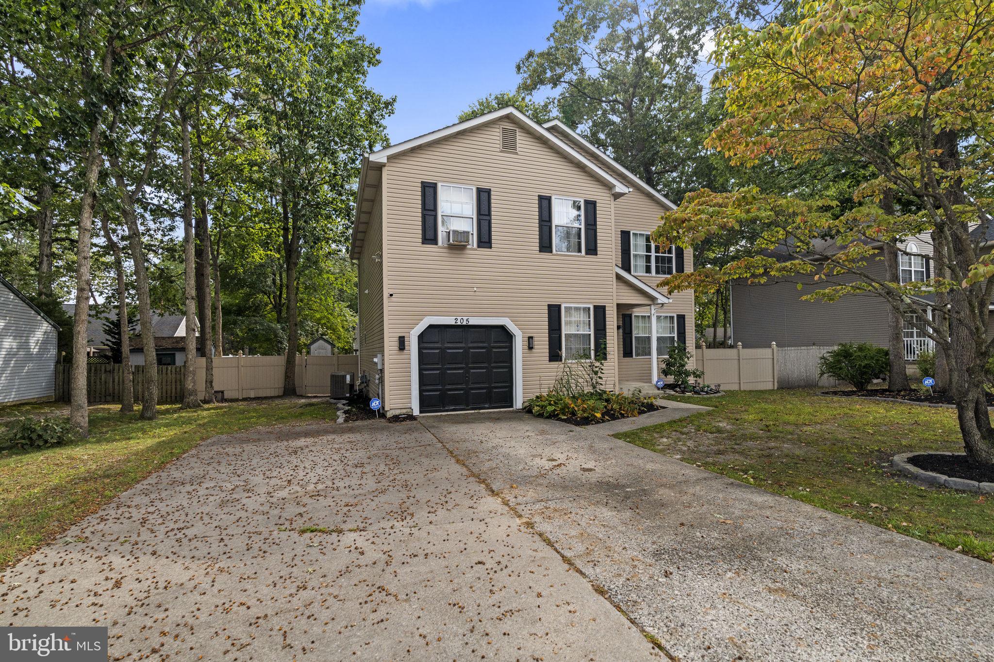 205 Franklin Avenue Berlin, NJ 08009 - Photo 2 of 36 a front view of a house with a yard and garage