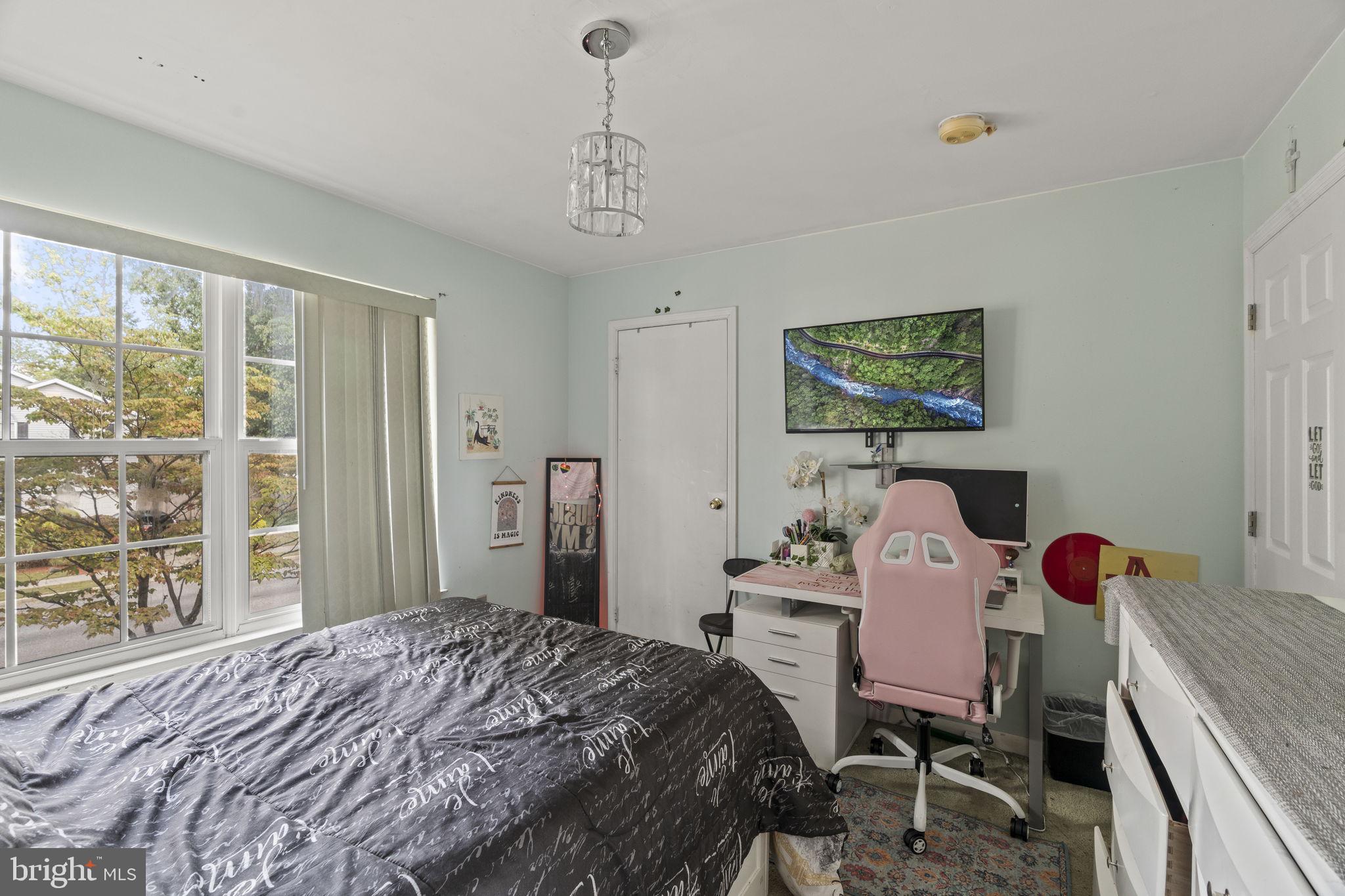 205 Franklin Avenue Berlin, NJ 08009 - Photo 24 of 36 a bedroom with a bed and a table in it
