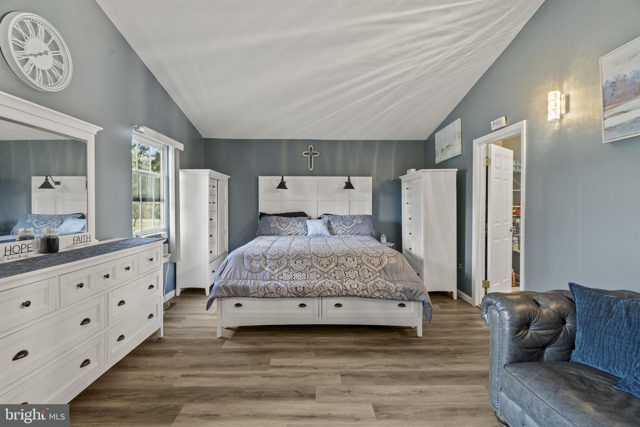 205 Franklin Avenue Berlin, NJ 08009 - Photo 26 of 36 a spacious bedroom with a bed a couch and dresser
