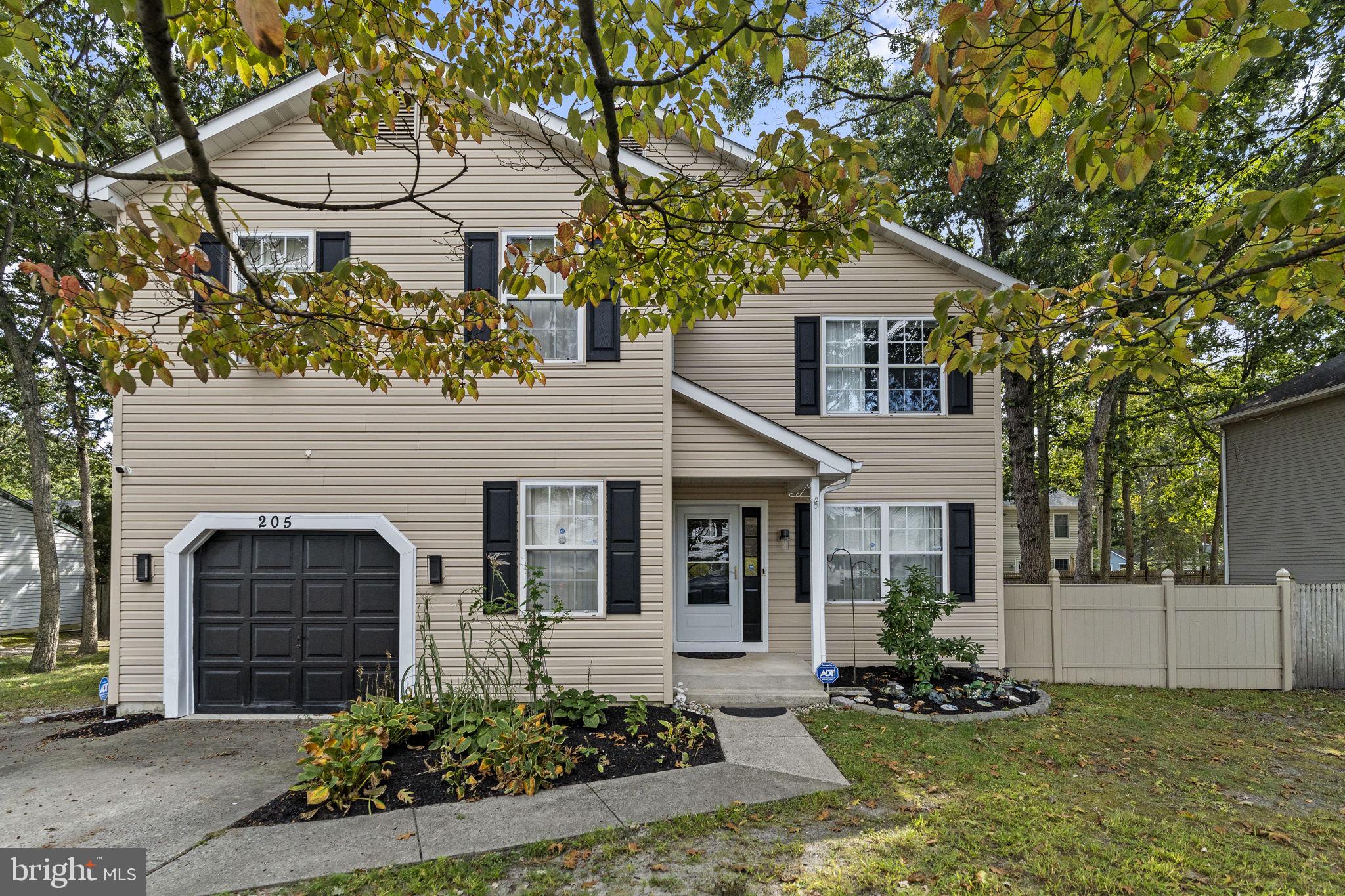 205 Franklin Avenue Berlin, NJ 08009 - Photo 3 of 36 a front view of a house with a yard and garage