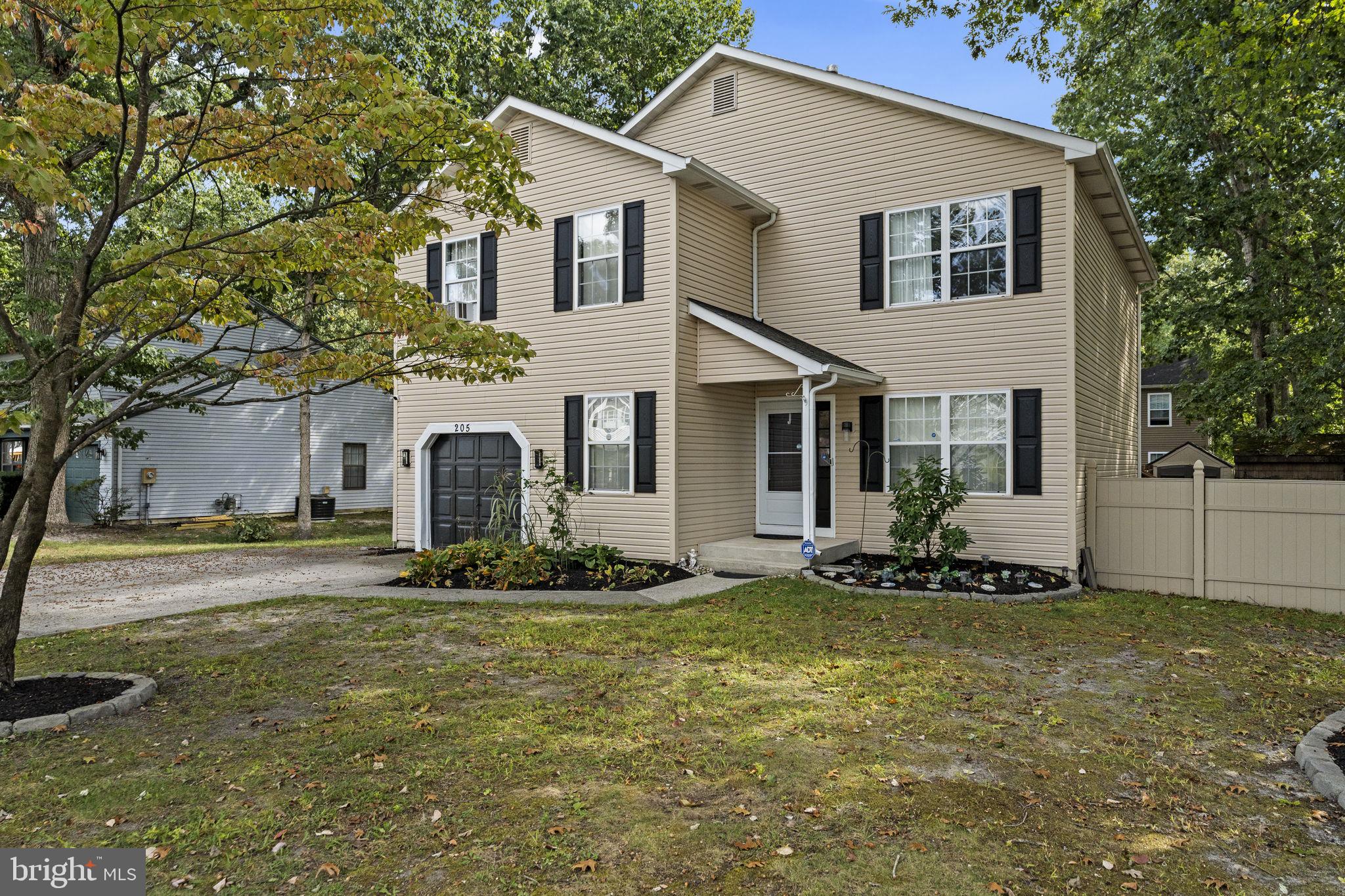 205 Franklin Avenue Berlin, NJ 08009 - Photo 4 of 36 a front view of a house with a yard