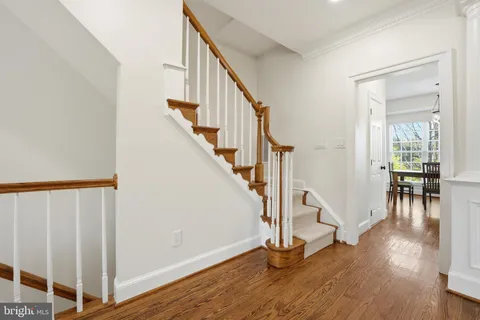 a kitchen with stainless steel appliances granite countertop a refrigerator sink and white cabinets