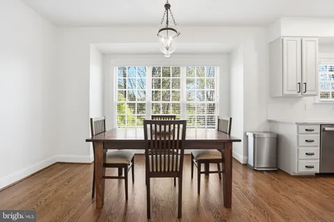 a kitchen with cabinets appliances and wooden floor