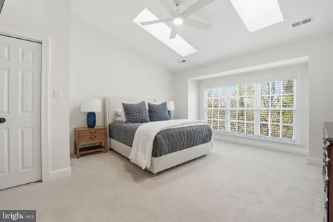 a spacious bathroom with a double vanity sink a bathtub and next to a window