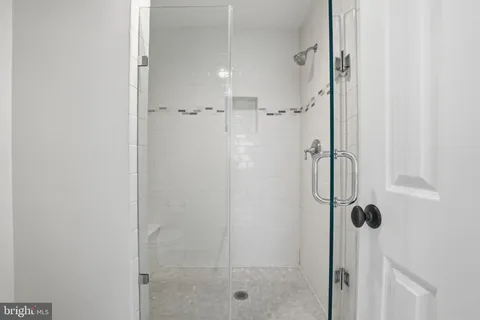 a bathroom with a glass shower door