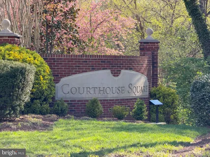 a view of a white house with a large garden and pathway