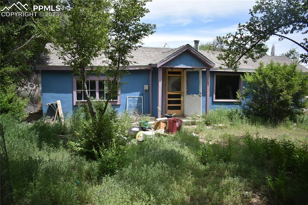 600 West 3rd Street Ordway, CO 81063 - Photo 9 of 25 a front view of house with yard and trees in the background