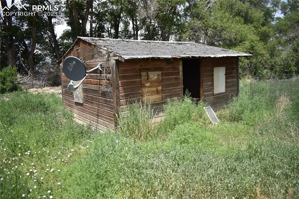 600 West 3rd Street Ordway, CO 81063 - Photo 10 of 25 a view of a backyard with barn plants and large tree