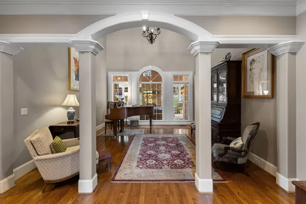 a living room with furniture a fireplace and a floor to ceiling window