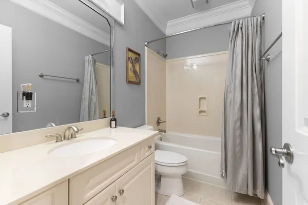 a living room with furniture a large window and chandelier