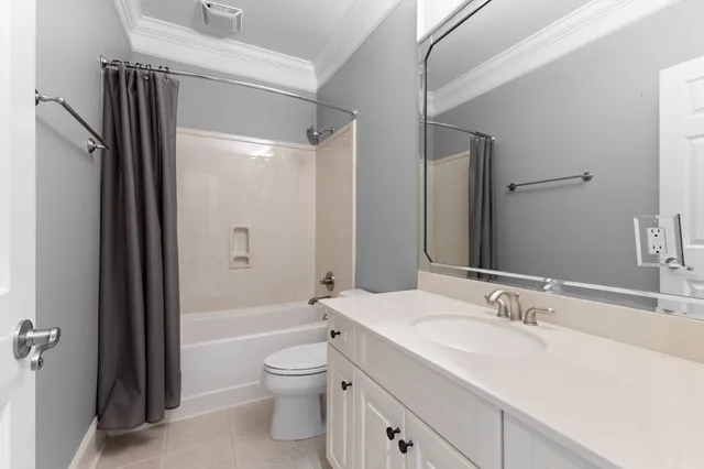a bathroom with a glass shower door and a window