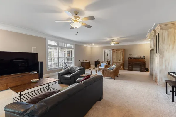 a view of a house with backyard sitting area and garden
