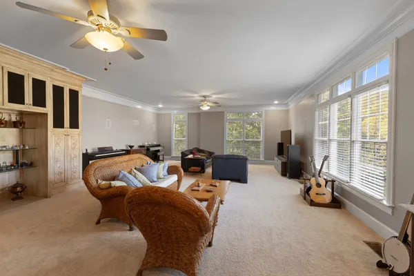a view of a patio with table and chairs potted plants and a large tree