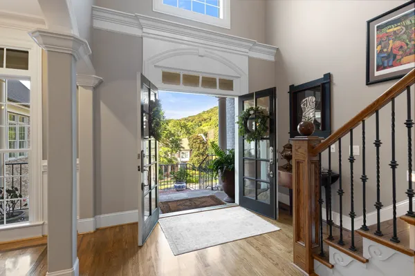 a view of entryway and hall with wooden floor