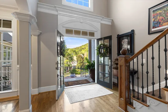 a view of entryway and hall with wooden floor
