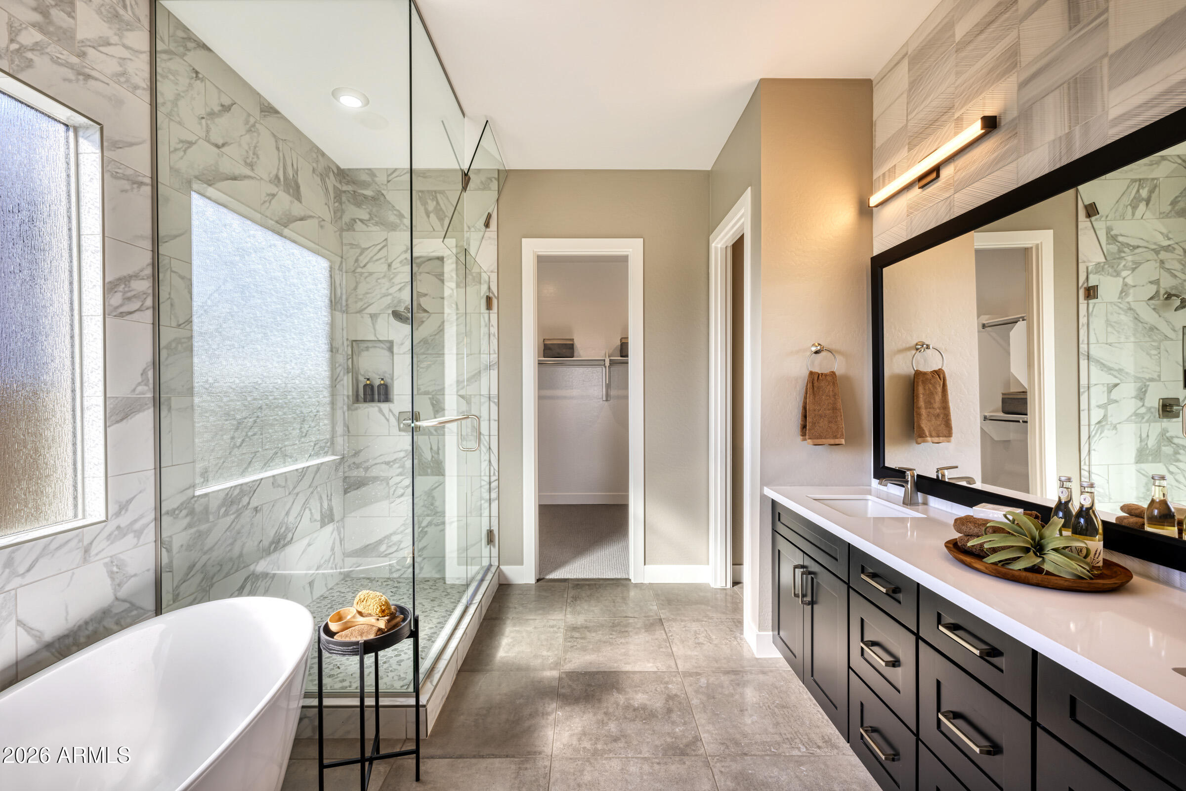 5737 South Quartz Street Gilbert, AZ 85298 - Photo 11 of 15 a bathroom with a granite countertop sink a mirror a bathtub and next to a window