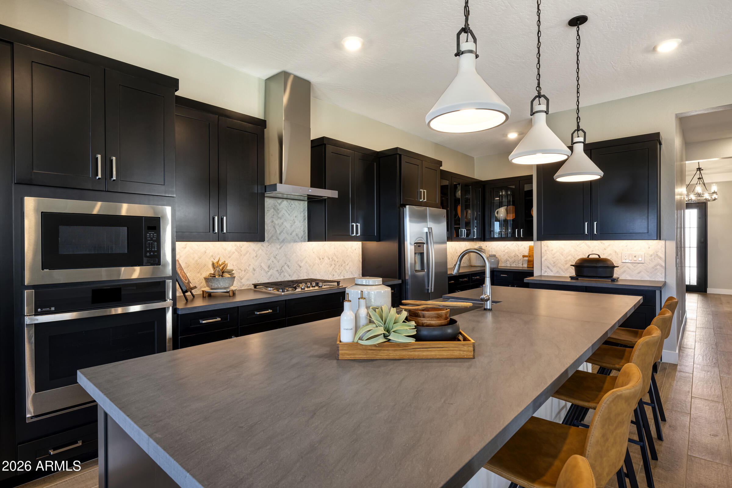 5737 South Quartz Street Gilbert, AZ 85298 - Photo 4 of 15 a kitchen with kitchen island a stove and a chandelier